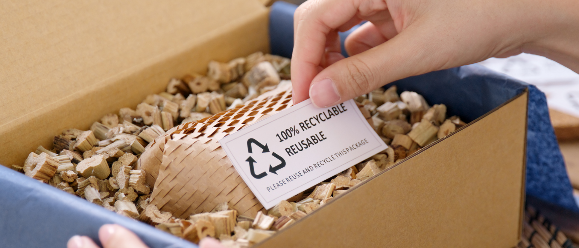 a_hand_placing_recyclable_label_on_package