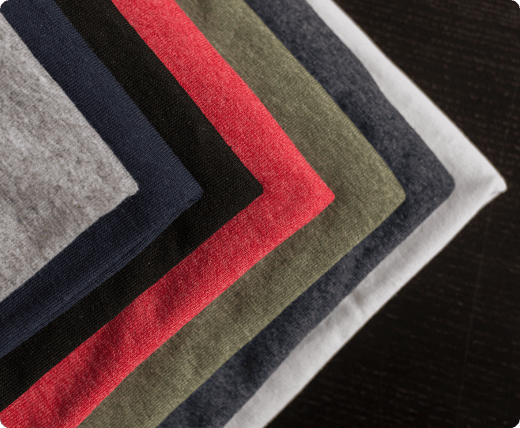 six_different_colored_folded_t-shirts_stacked_together